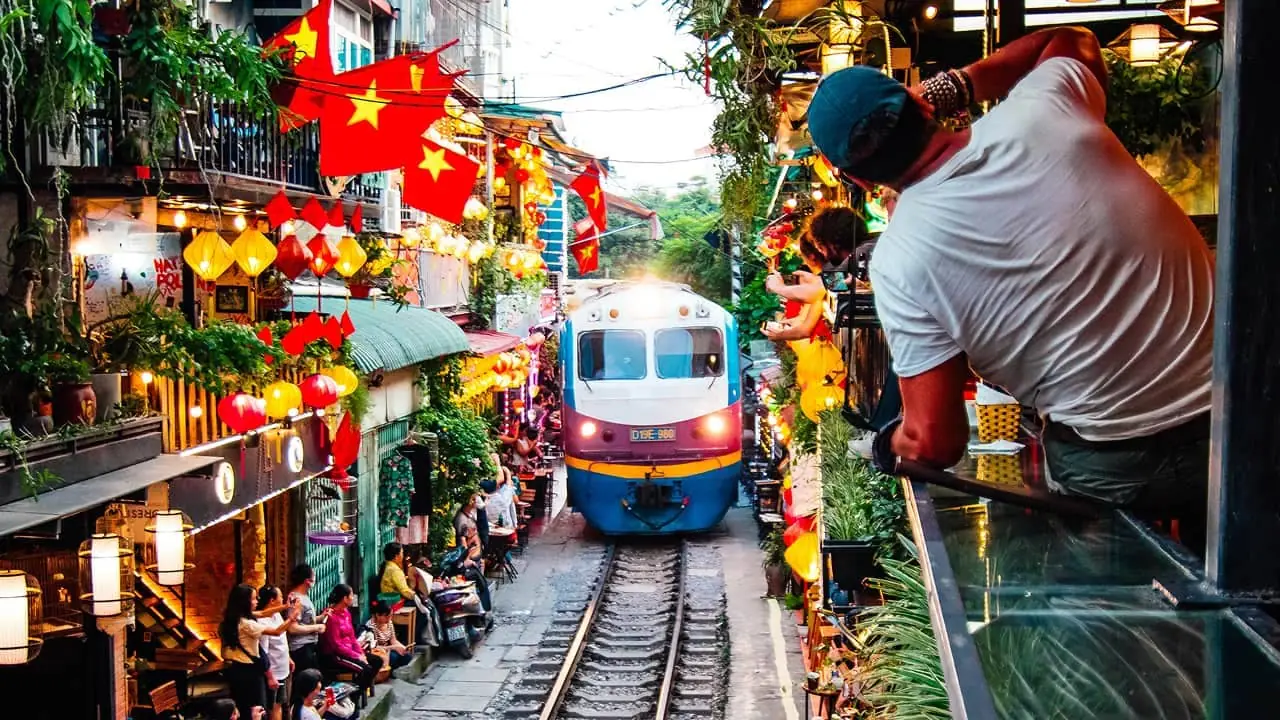 A train passing through Hanoi's train street at night